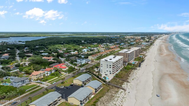 drone / aerial view with a water view and a beach view