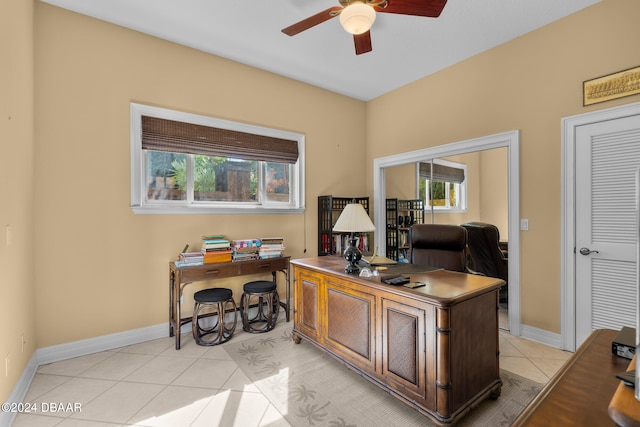 home office with plenty of natural light, light tile patterned floors, and ceiling fan