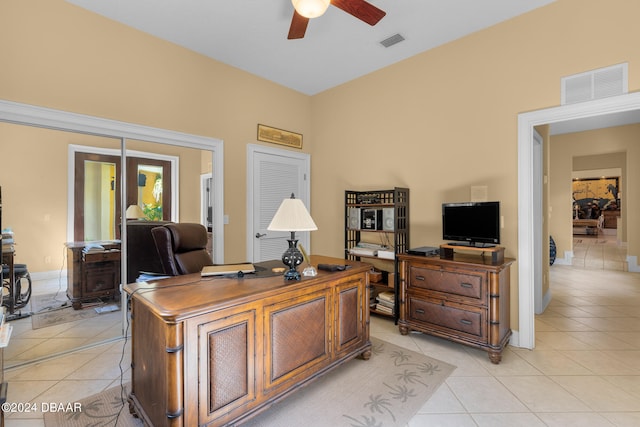 tiled home office featuring ceiling fan