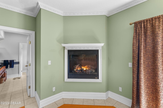 room details featuring tile patterned flooring, a textured ceiling, and ornamental molding