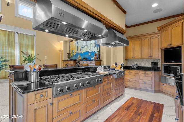 kitchen with island range hood, ventilation hood, crown molding, light tile patterned floors, and stainless steel gas cooktop