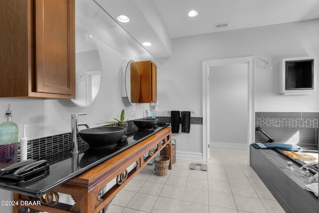 kitchen featuring light tile patterned flooring and sink