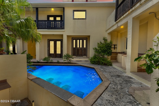 view of pool featuring a patio area and french doors