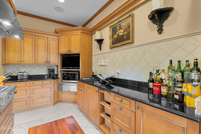 kitchen with dark stone countertops, ventilation hood, light tile patterned floors, and ornamental molding