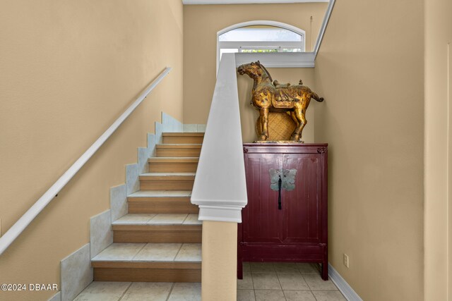 staircase with tile patterned floors