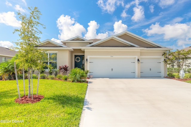 view of front of home featuring a front lawn and a garage