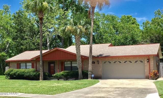 1975 Red Cedar Cir S, Daytona, FL 32119 - single story home with a front yard, an attached garage, concrete driveway, and roof with shingles