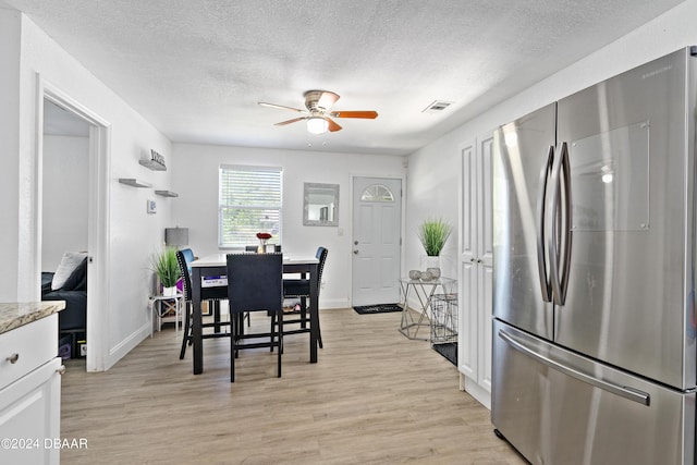 1318 San Jose Blvd, Daytona Beach, FL 32117 - dining space with a ceiling fan, a textured ceiling, light wood-style flooring, and baseboards