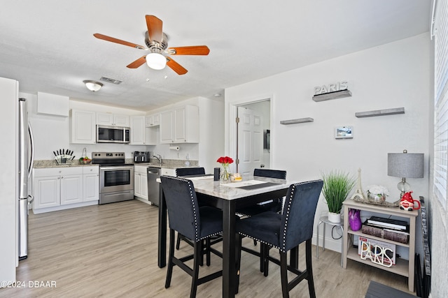 1318 San Jose Blvd, Daytona Beach, FL 32117 - dining room featuring light wood-type flooring and ceiling fan