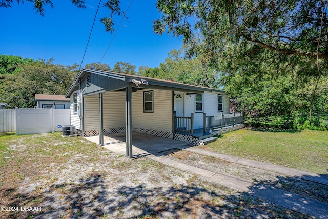 1318 San Jose Blvd, Daytona Beach, FL 32117 - view of front of property with a carport and central AC unit