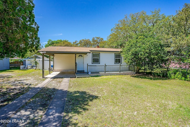 1318 San Jose Blvd, Daytona Beach, FL 32117 - view of front of property with concrete driveway, an attached carport, a chimney, and covered porch