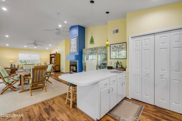6361 Turtlemound Rd, New Smyrna Beach, FL 32169 - kitchen featuring a peninsula, open floor plan, visible vents, and wood finished floors