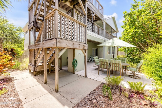 6361 Turtlemound Rd, New Smyrna Beach, FL 32169 - view of patio / terrace with stairway and outdoor dining space