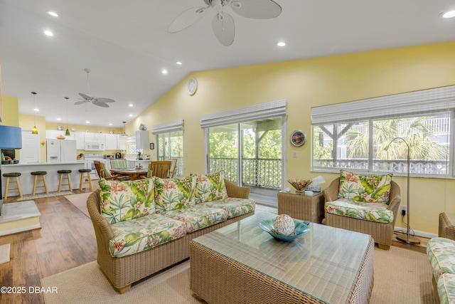 6361 Turtlemound Rd, New Smyrna Beach, FL 32169 - living room with a ceiling fan, recessed lighting, vaulted ceiling, and light wood-type flooring