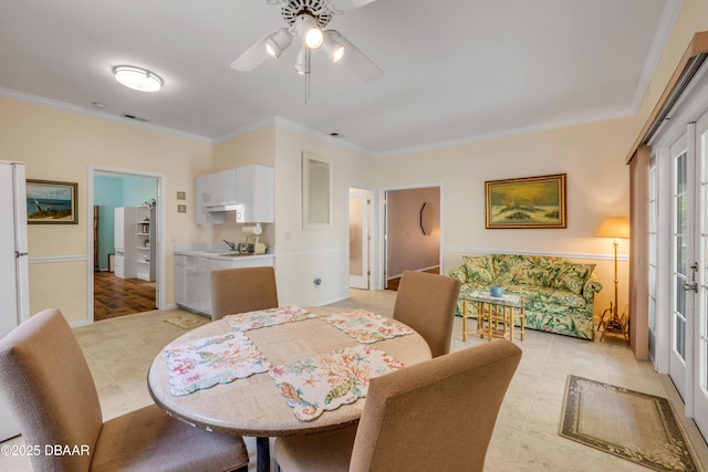 6361 Turtlemound Rd, New Smyrna Beach, FL 32169 - dining room featuring crown molding, a ceiling fan, visible vents, and light tile patterned floors