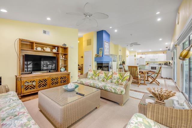 6361 Turtlemound Rd, New Smyrna Beach, FL 32169 - living area with a ceiling fan, recessed lighting, lofted ceiling, and visible vents