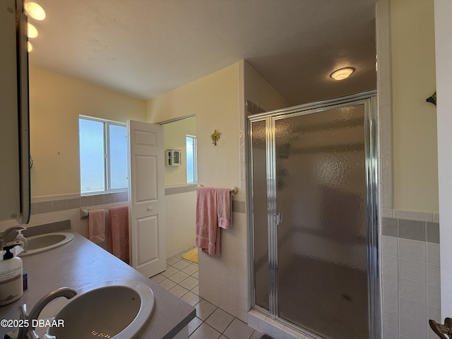 6361 Turtlemound Rd, New Smyrna Beach, FL 32169 - bathroom featuring a sink, tile walls, tile patterned flooring, and a wainscoted wall