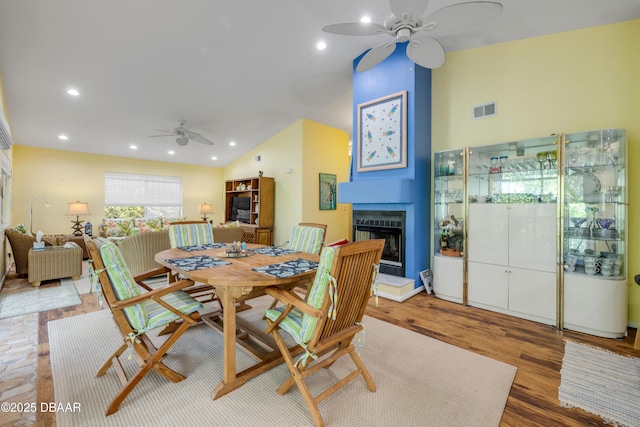 6361 Turtlemound Rd, New Smyrna Beach, FL 32169 - dining room featuring visible vents, wood finished floors, ceiling fan, recessed lighting, and a large fireplace