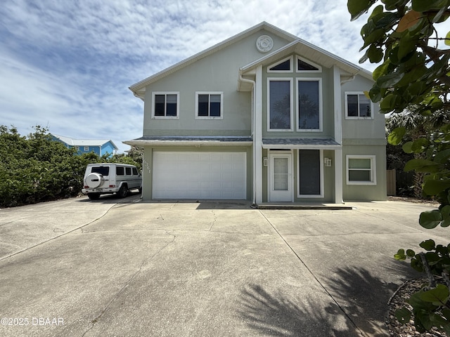 6361 Turtlemound Rd, New Smyrna Beach, FL 32169 - traditional-style home featuring an attached garage, stucco siding, and concrete driveway