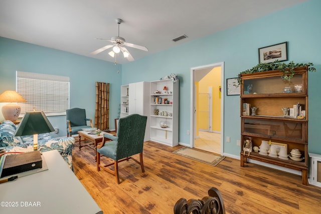 6361 Turtlemound Rd, New Smyrna Beach, FL 32169 - sitting room with baseboards, ceiling fan, visible vents, and wood finished floors