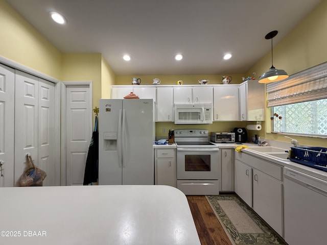 6361 Turtlemound Rd, New Smyrna Beach, FL 32169 - kitchen featuring white cabinets, white appliances, light countertops, decorative light fixtures, and dark wood-style floors