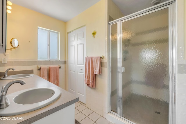 6361 Turtlemound Rd, New Smyrna Beach, FL 32169 - bathroom featuring tile patterned floors, tile walls, a sink, and a stall shower