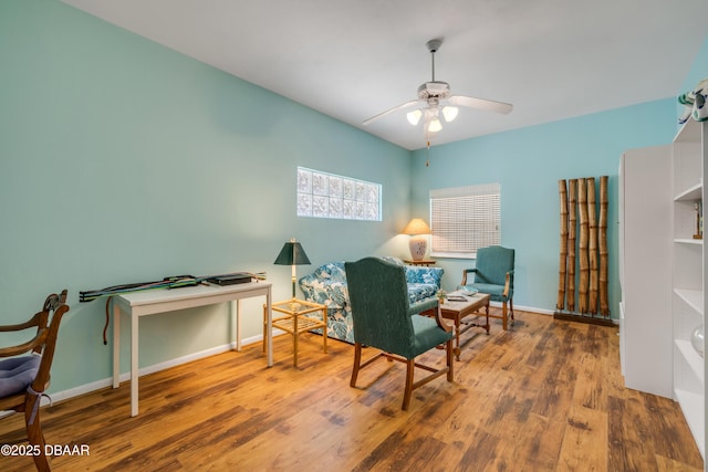 6361 Turtlemound Rd, New Smyrna Beach, FL 32169 - living area with baseboards, a ceiling fan, and wood finished floors