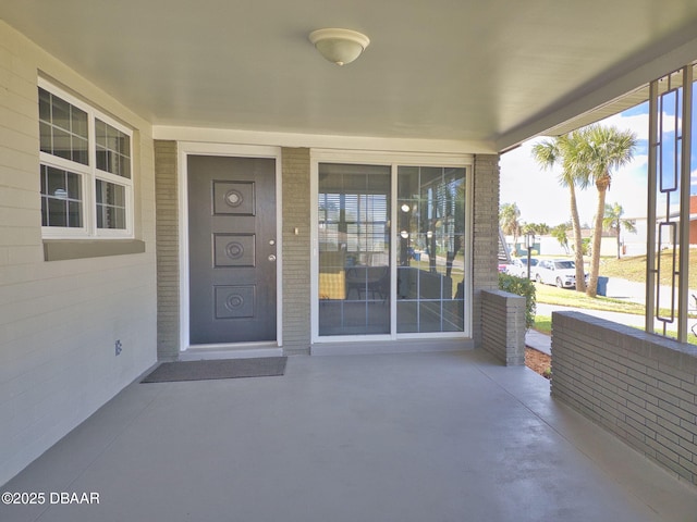 property entrance featuring a patio area