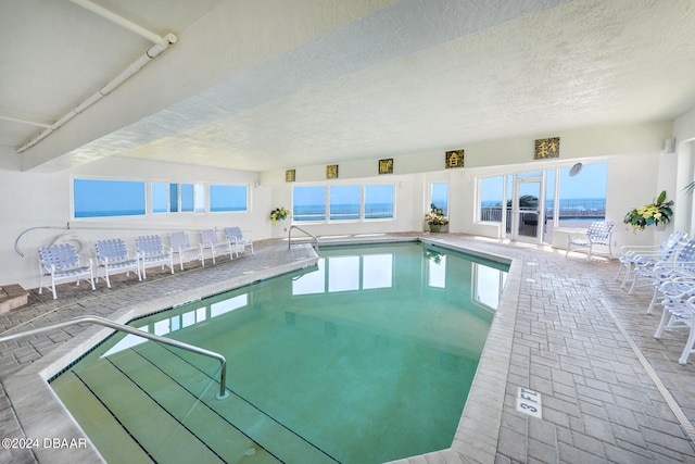 view of pool with a water view