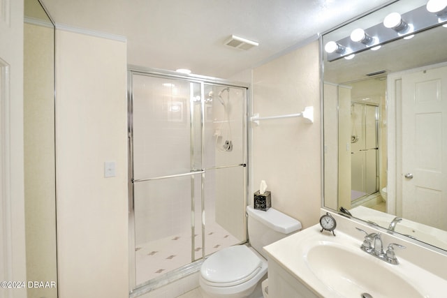 bathroom featuring toilet, vanity, and an enclosed shower