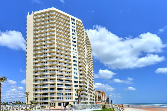 view of property featuring a beach view and a water view