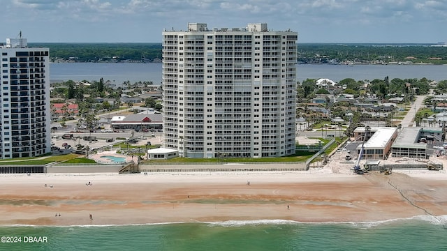 bird's eye view with a water view and a beach view