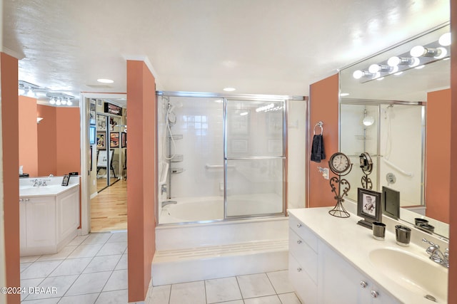 bathroom featuring vanity, enclosed tub / shower combo, tile patterned flooring, and ornamental molding