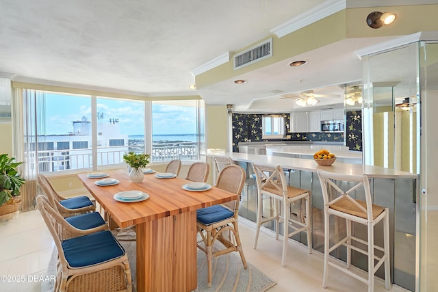 2545 S Atlantic Ave Unit 2107 2108, Daytona Beach Shores, FL 32118 - dining space with light tile patterned floors, crown molding, and ceiling fan