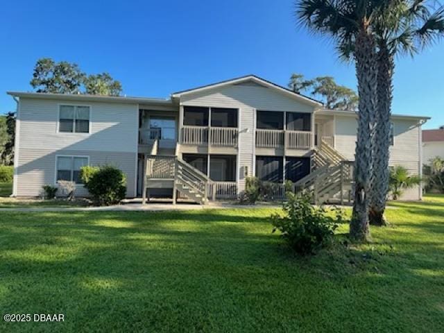 rear view of property with a lawn