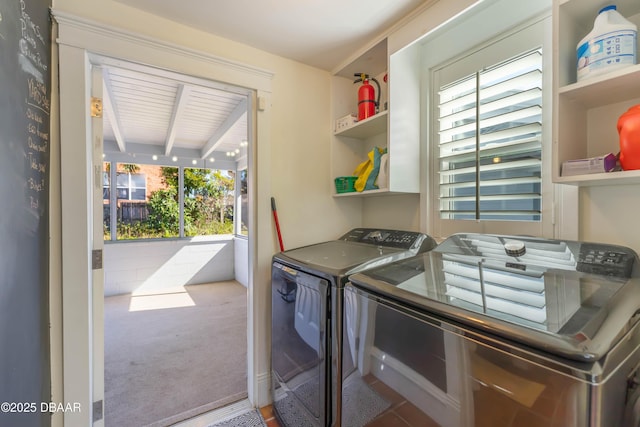 clothes washing area with laundry area, separate washer and dryer, and carpet floors