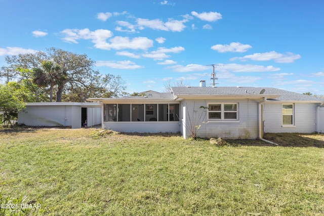 back of property featuring a sunroom and a lawn