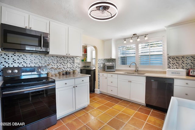 kitchen with white cabinets, stainless steel appliances, and light countertops