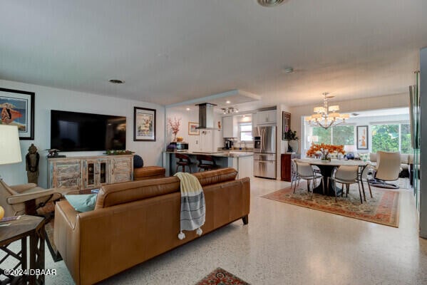 living room with a healthy amount of sunlight and an inviting chandelier