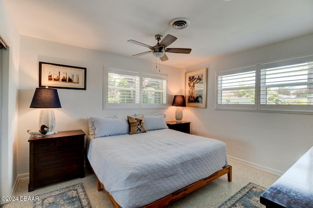 bedroom with multiple windows and ceiling fan