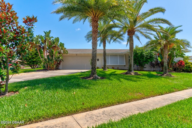 view of front facade with a garage and a front lawn