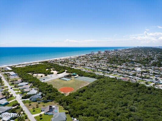 drone / aerial view featuring a view of the beach and a water view