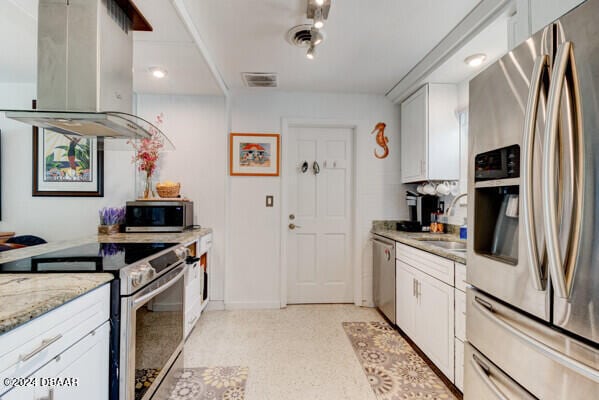 kitchen with white cabinetry, appliances with stainless steel finishes, and island exhaust hood