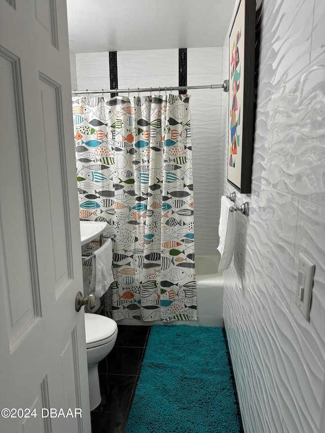 bathroom featuring tile patterned flooring, shower / bath combo with shower curtain, and toilet