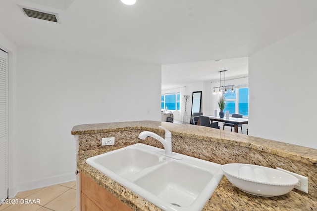 3315 S Atlantic Ave Unit 408, Daytona Beach Shores, FL 32118 - kitchen with light tile patterned floors, light countertops, and pendant lighting