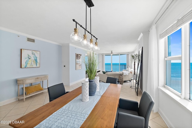 3315 S Atlantic Ave Unit 408, Daytona Beach Shores, FL 32118 - dining space featuring light tile patterned floors and ornamental molding