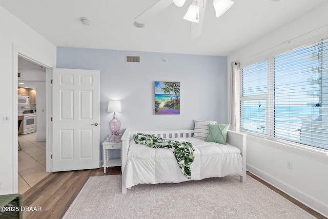 3315 S Atlantic Ave Unit 408, Daytona Beach Shores, FL 32118 - bedroom with wood finished floors and ceiling fan