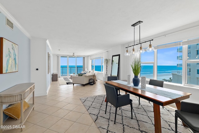3315 S Atlantic Ave Unit 408, Daytona Beach Shores, FL 32118 - dining space featuring light tile patterned floors, a water view, and crown molding