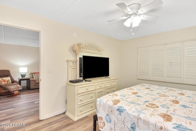 bedroom featuring light wood-type flooring, ceiling fan, and baseboards
