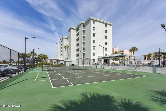 view of tennis court with fence